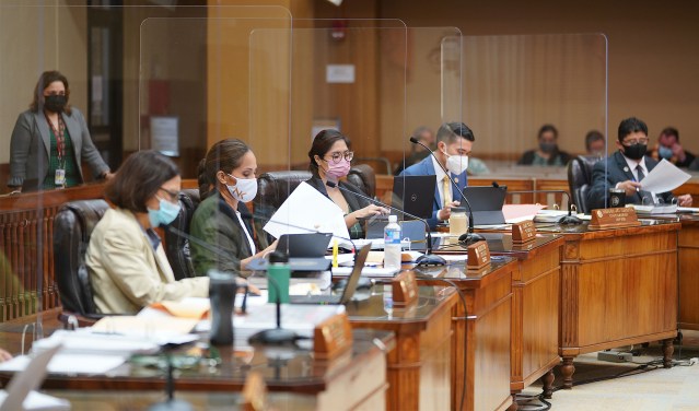 Honolulu City Council sit with plexiglass dividers between their desks at Honolulu Hale during the COVID-19 pandemic.