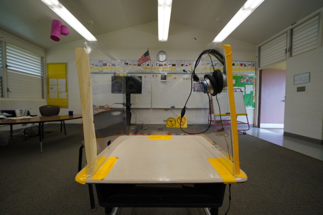 Lanai High and Elementary School with socially distanced desks and plastic COVID-19 barriers.