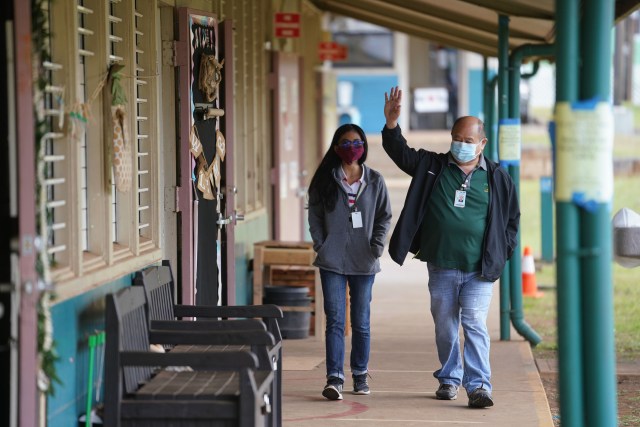 Lanai High and Elementary School teacher Daisy Lyn Dela Rosa walks with Principal Elton Kinoshita.