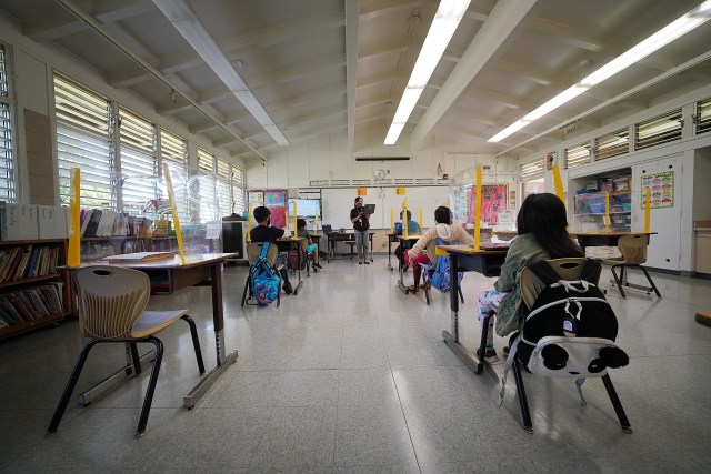 Lanai High and Elementary School. Elementary school teacher Ninez Abonal teaches as students are socially distanced and sit behind plastic barriers.