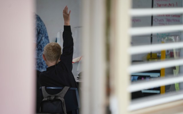 Lanai High and Elementary School teacher student raises hand in class.