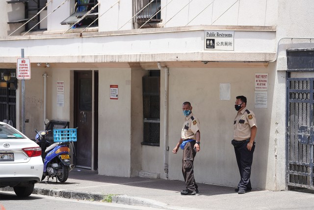 Private security personnel make their rounds across the street from the River of Life Mission located near Pauahi and Maunakea Streets.