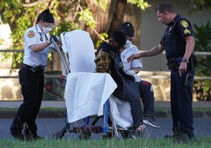EMS and HPD assist with suspect along Kalakaua Avenue after 16-year-old driver was shot and killed by police.