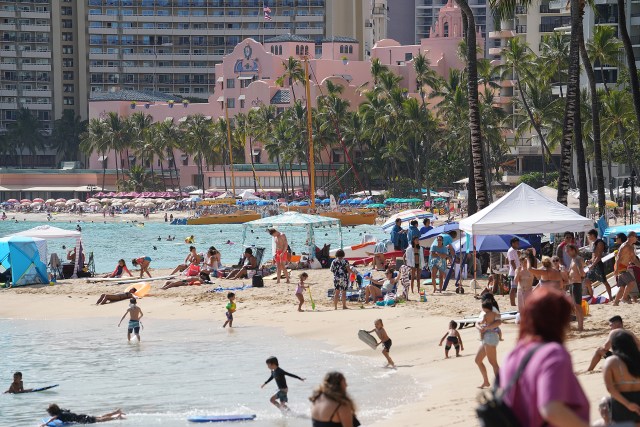 Sunday at Waikiki Beach with a backgrop of the Royal Hawaiian Hotel and beachgoers and public enjoying the beach during the COVID-19 pandemic. April 11, 2021
