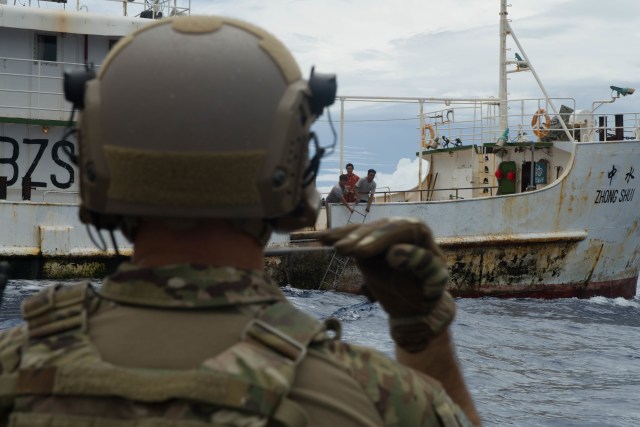 PACIFIC OCEAN (Nov. 29, 2016) U.S. Coast Guard Pacific Law Enforcement Detachment Team Boarding Officer signals a Chinese fishing vessel not to use a boarding ladder during a Oceania Maritime Security Initiative (OMSI) mission with Arleigh Burke-class guided-missile destroyer USS Sampson (DDG 102). Sampson reports to U.S. Third Fleet, headquartered in San Diego, while deployed to the Western Pacific as part of the U.S. Pacific Fleet-led initiative to extend the command and control functions of Third Fleet into the region. (U.S. Navy photo by Petty Officer 2nd Class Bryan Jackson/Released)