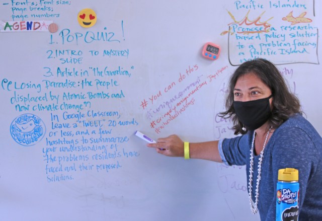 Teacher Tiffany Edwards-Hunt goes over an assignment at Keaau Middle School during Friday's class with a mix of in-class and remote learning students. Photo: Tim Wright