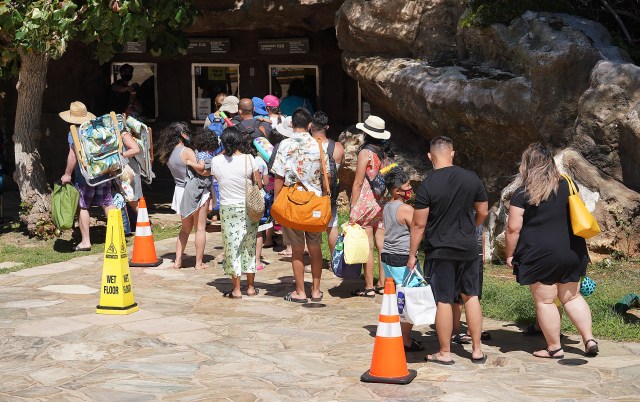 Hanauma Bay State Park visitors stand in line to pay their admission fees.