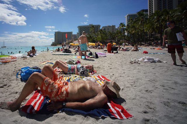 Beachgoers enjoy the sun at Waikiki Beach during the COVID-19 pandemic.