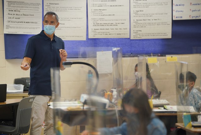 Holomua Elementary School 4th grade teacher, Mr. Suan, teaches students.