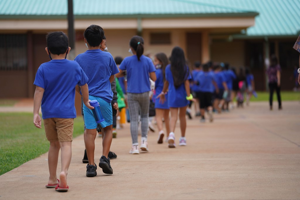 Holomua Elementary School students lineup and head back to their classrooms after recess.