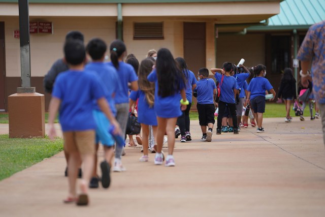 Holomua Elementary School students walk back to their classrooms after recess.