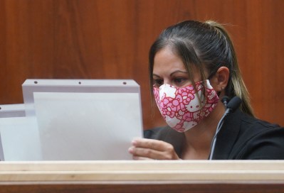 Honolulu police officer Chanel Price listens to questions from Prosecutor Christopher Van Marter while looking at still frames of video evidence in Judge William M. Domingo’s courtroom. Prosecutor Christopher Van Marter introduces evidence in Judge William M. Domingo courtroom during the third day of preliminary hearings for three Honolulu police officers in the alleged killing of Iremamber Sykap in Honolulu. (POOL PHOTO/Cory Lum/Honolulu Civil Beat)