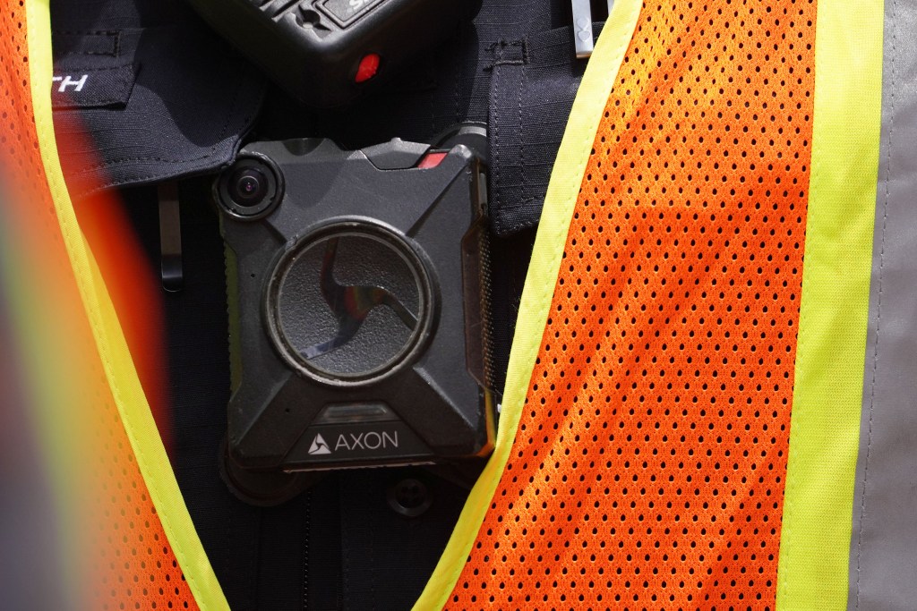 Honolulu Police Officer wears an AXON body camera outside district court. The charges of second-degree murder against officer Geoffrey H.L. Thom, 42, a five-year veteran of the force, and second-degree attempted murder against Zackary K. Ah Nee, 26, a three-year HPD veteran, and his partner Christopher J. Fredeluces, 40, who has 10 years of service with the department, were brought by criminal complaint after an Oahu grand jury declined to indict the officers.