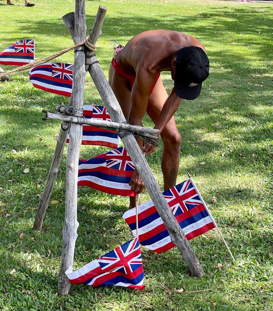 Kaue nahoi placing flags in the ground around Thomas Square Park in Honolulu on July 31, 2021. At the "Lā Hoʻihoʻi Ea Honolulu" also known as Hawaiian Restoration Day. Comemmorating the return of the Hawaiian Kingdom's Sovereignty from Britain 178 years ago. Photo/Ronen Zilberman Civil Beat