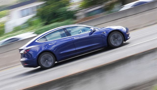 A Tesla electric car on the freeway.