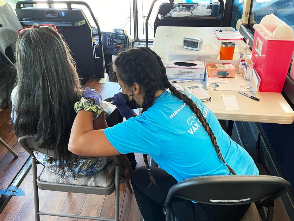 Hawaii Pacific Health’s Vax Squad bus team member, Kayla Guillarmo administers a COVID-19 vaccine at the Honolulu Zoo on Friday, July 16, 2021. The Honolulu Zoo hosted the event in partnership with the City and County of Honolulu, Hawai‘i State Department of Health, and Hawaii Pacific Health. (Ronen Zilberman photo Civil Beat)