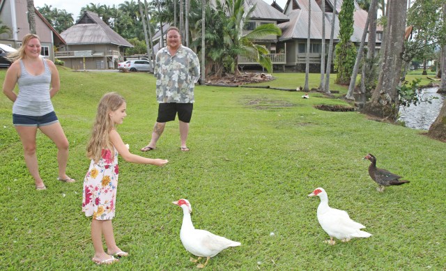 Brenya Bailey (age 5) loves to feed geese and ducks on the grounds of Waiakea Villas as her parents Michael and Shirlene, look on. Waiakea Villas is the only home Brenya has known as the family face an upcoming eviction in August. Photo: Tim Wright