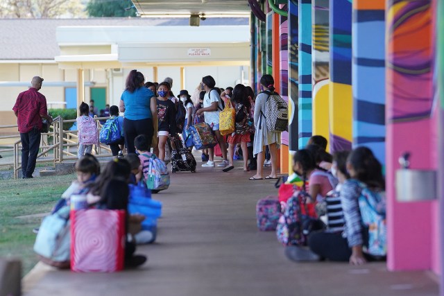 Aliiolani Elementary School students wait outside classrooms before the start of the first day of school during a COVID-19 pandemic.