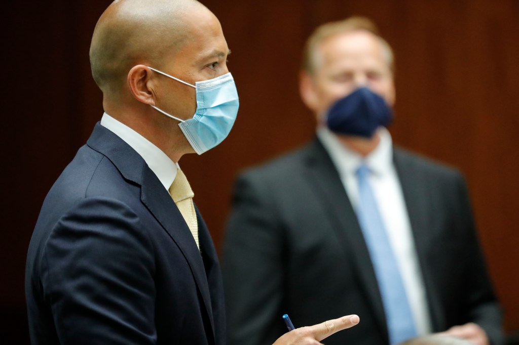 Defense attorney Thomas Otake speaks as prosecuting attorney Christopher Van Marter looks on at right in the district courtroom of Judge William M. Domingo during preliminary hearings for three Honolulu police officers in the killing of Iremamber Sykap on Tuesday, Aug. 17, 2021, in Honolulu. (POOL PHOTO/Jamm Aquino/Honolulu Star-Advertiser).