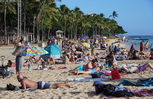 Beachgoers enjoy the sunshine at Queens Beach on August 22, 2021.