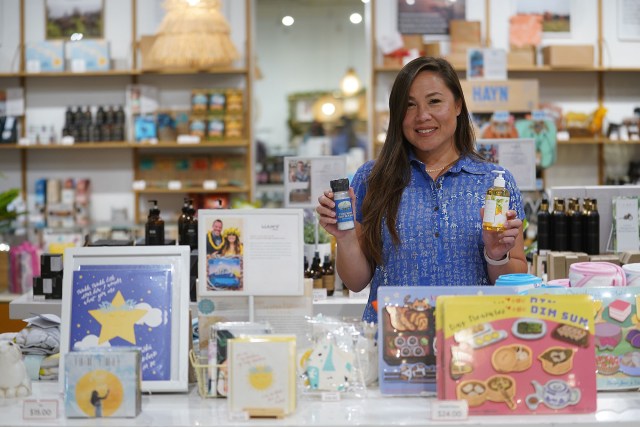 Meli James holds some of the ‘made in Hawaii’ goods featured at the retail shop called House of Mana Up inside the Royal Hawaiian Shopping Center.