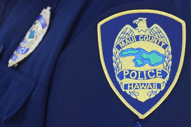 Maui County Police uniform on an officer sitting in the Molokai Police Department parking lot.