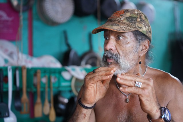Molokai resident Thadd Camara sits in his living area that he built on property located on Molokai Hawaiian homestead land near the Molokai Airport.