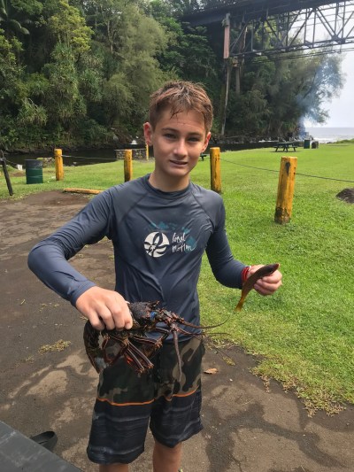 Isiah Ishigo hold his fresh catch of the day in Kolekole Beach Park.
