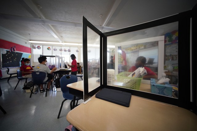 Students work with plastic barriers in Pauoa Elementary School 5th grade Teacher Jeanne Oliveira’s classroom during the Covid-19 pandemic. October 28, 2021