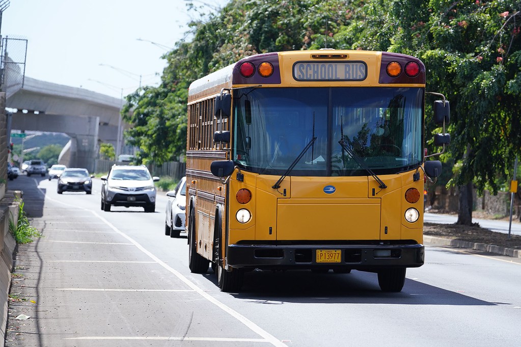 A school bus heads towards Pearl City along Farrington Highway.