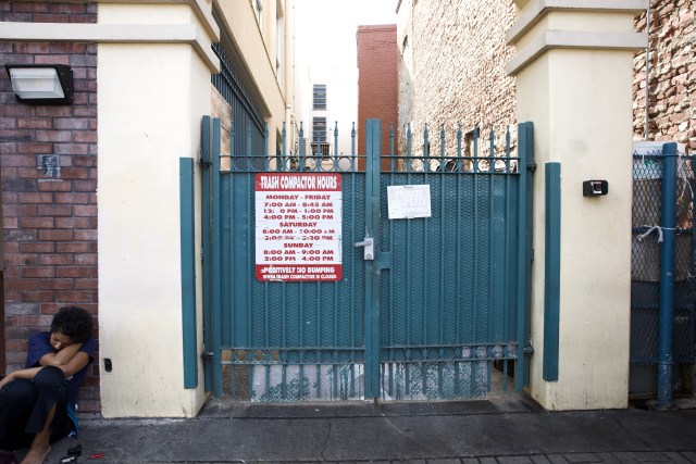 Large dumpsters sit behind the locked gate in Chinatown.