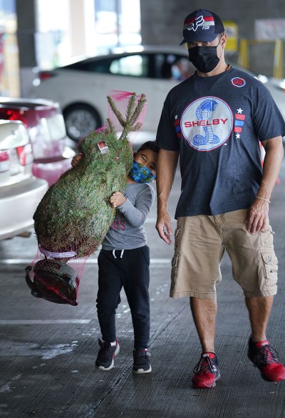 5-year-old Justin Moniz helps dad Dwayne Moniz with the newly purchased tree at Home Depot.