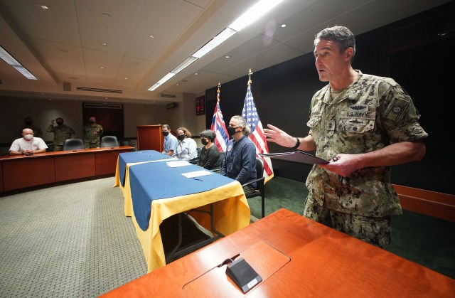 Rear Admiral Blake Converse speaks before a ‘photo op’ at the CINCPAC command center with left-right, Chief of Environmental Division US Army Garrison Hawaii, Sherri R. Eng N45 Commander, Navy Region Hawaii by direction of the Commander, Kathleen S. Ho, Deputy Director of Environmental Health, Hawaii Department of Health, and right, Ben Castellana, On Scene Coordinator, US EPA Region 9.