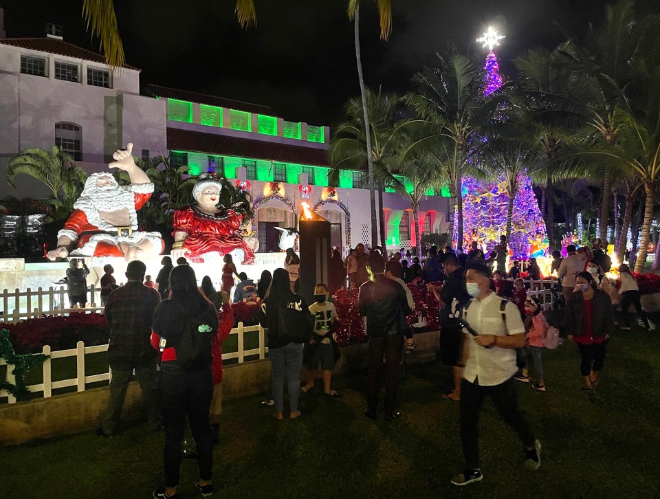 People gather in from of the Honolulu Hale to view the annual Christmas decorations on display for the holiday season in 2021.