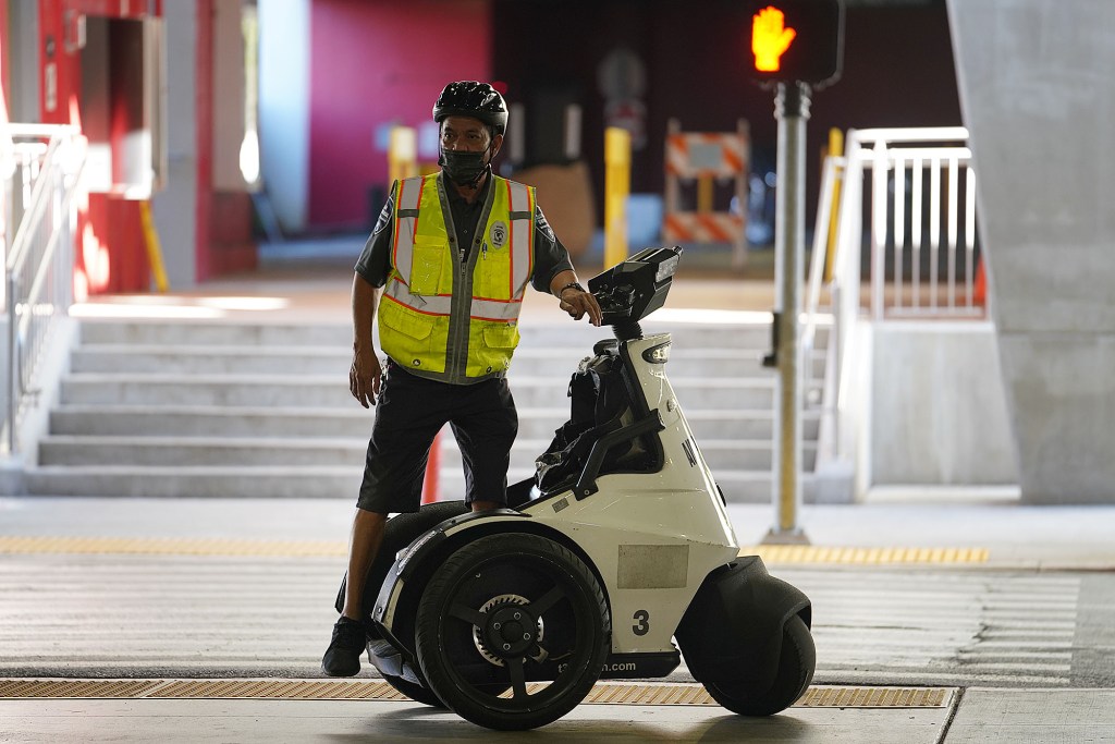 Security personnel at the Daniel K. Inouye International Airport during surge in Covid-19 cases.