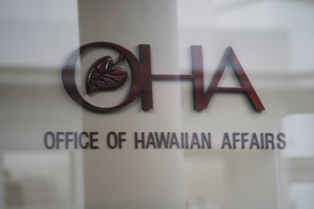 OHA Office of Hawaiian Affairs sign. Photograph made thru the glass entrance area.