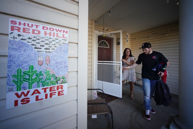 Christine Robert leaves home with her son, Christian Cook and other kids after stopping briefly at their Halsey Terrace home. Mom, Christine stopped at home to do some online tutoring as then headed back to the Outrigger Hotel where they are living due to Red Hill water issues at their housing at Halsey Terrace.