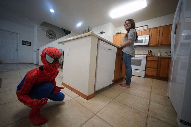 Jennifer Camp with son Ben Camp while he plays in a Spiderman costume before they head to the Princess Kaiulani hotel daily to shower and sleep.