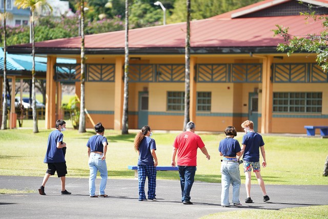 Students walk with a teacher while on the Kea'au High School campus located on Hawaii island.