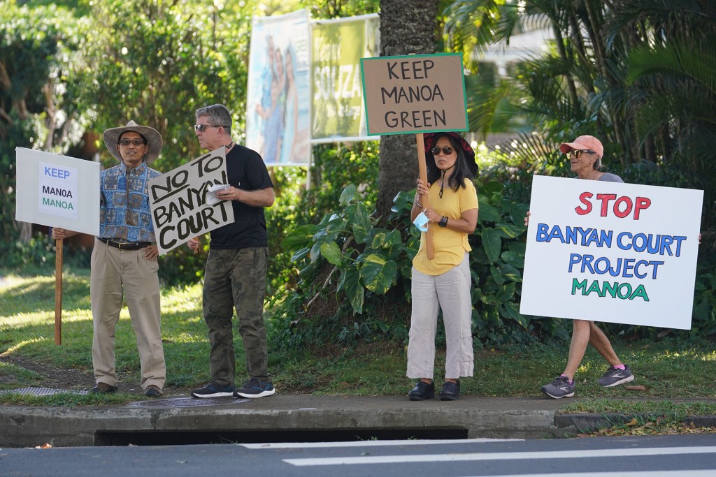 Demonstrators opposing Manoa Banyan Court project gather near University Avenue and East Manoa Road.