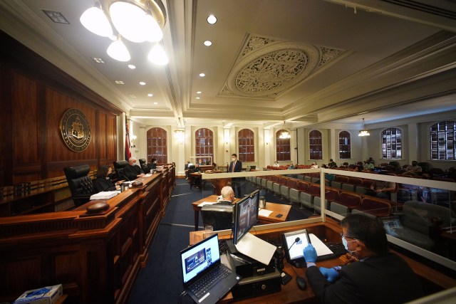 Hawaii State Supreme Court Chief Justice Mark Recktenwald flanked by associate justices hear oral arguments on a reapportionment case.