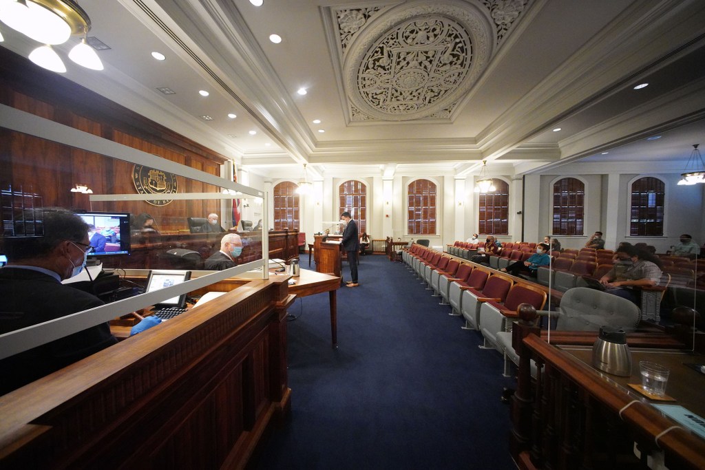 Hawaii State Supreme Court Chief Justice Mark Recktenwald flanked by associate justices listen to oral arguments on a reapportionment case.