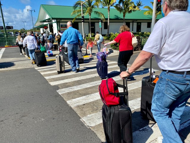 A photo of visitors exiting the Kahului Airport