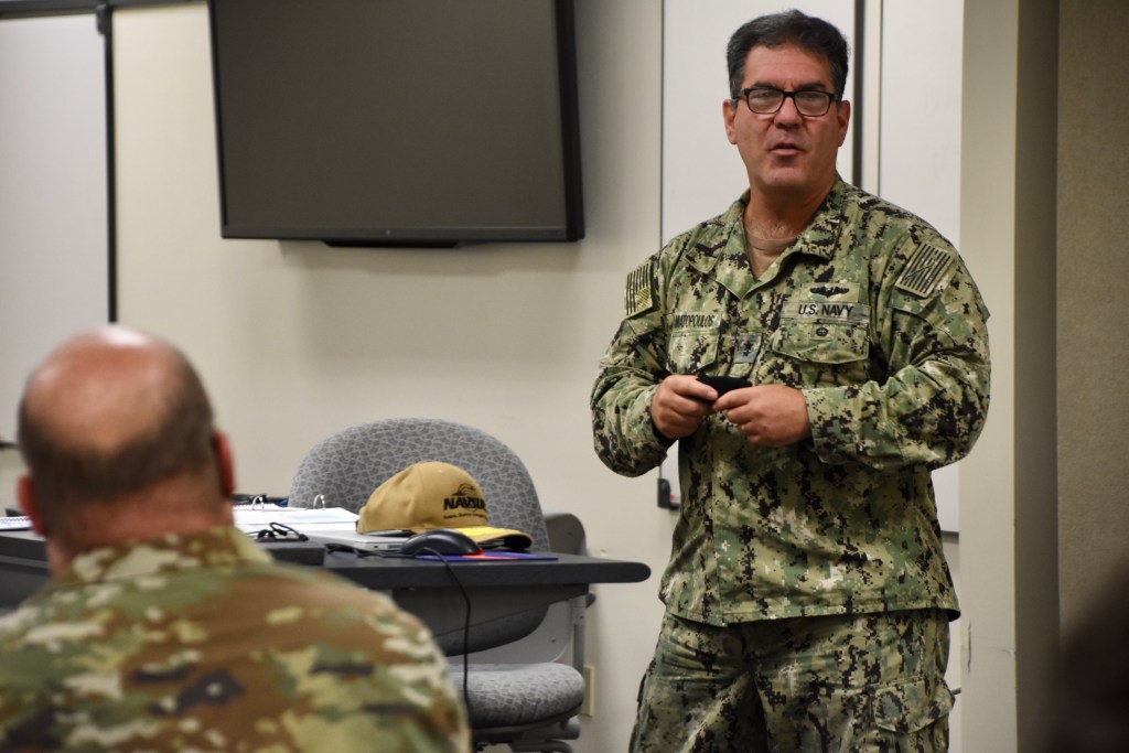 Rear Adm. Peter Stamatopoulos, Naval Supply Systems Command (NAVSUP) commander and 49th chief of Supply Corps, speaks to students at a Joint Operational Contracting Support (OCS) Planning and Execution Course (JOPEC) held at Naval Support Activity Mechanicsburg, Pa., Aug. 17, 2021. NAVSUP hosted more than 20 personnel from across the Department of Defense Aug. 16-27 for the first time the command has ever hosted the 10-day course. (U.S. Navy photo by Ted Nichols/Released)