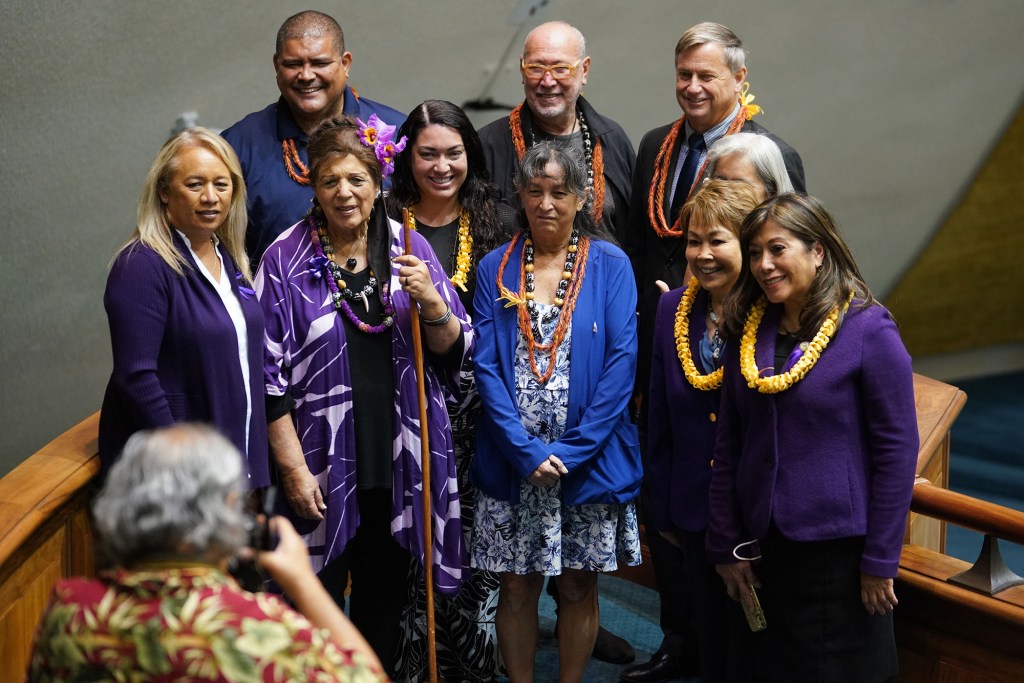 Left, Senator Lynn DeCoite, Gil Riviere and right, Senator Lorraine Inouye pose with Ahu Moku delegates after the floor session held at the Capitol..