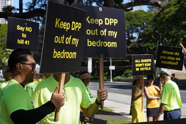 Demonstrators in opposition to Bill 41 hold signs on King Street near Honolulu Hale.