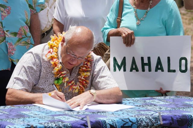 Mayor Rick Blangiardi signs Bill 41 into law at the Kailua Beach Park during a press conference.