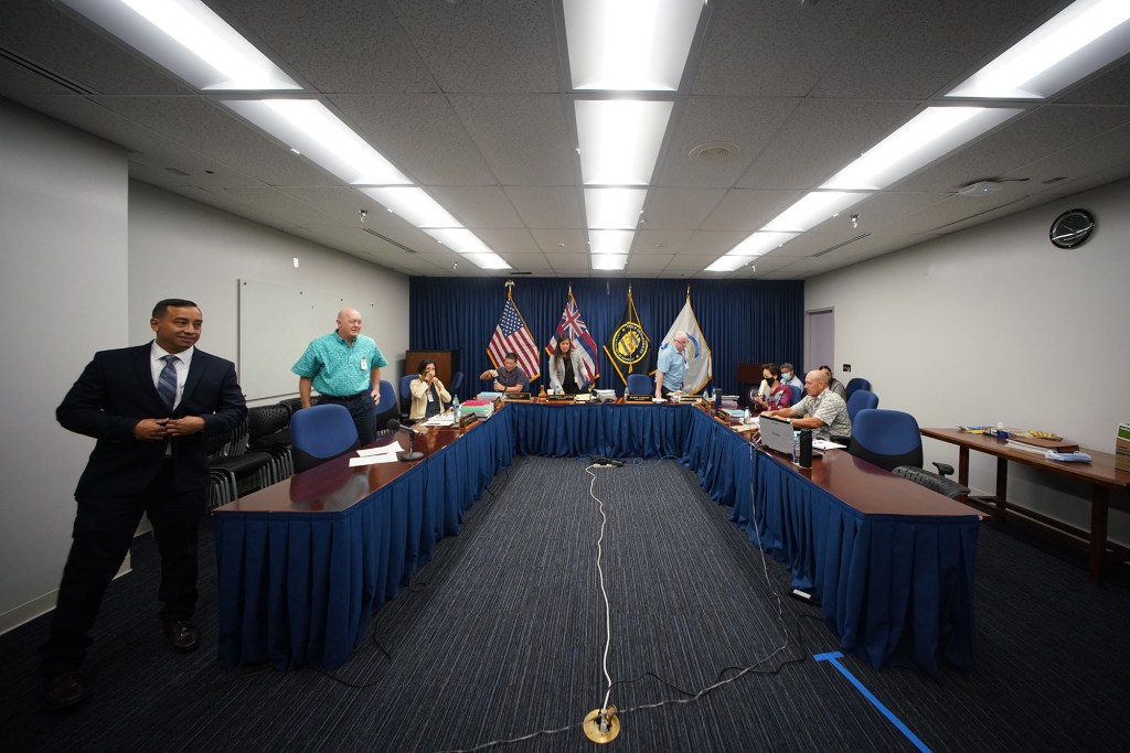 Honolulu Police Commission chief candidate Mike Lambert stands as a fire alarm goes off in the building during the meeting. 20 minutes later the all clear was given and Lambert was able to finish his closing remarks.