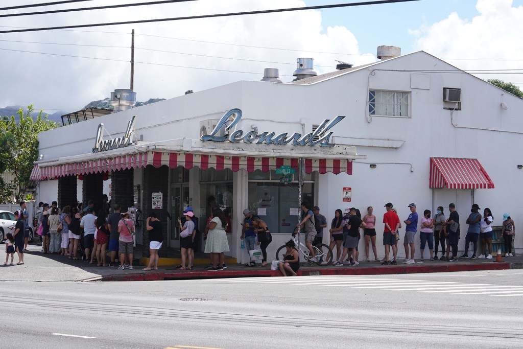 Customers line up outside Leonard's Bakery..
