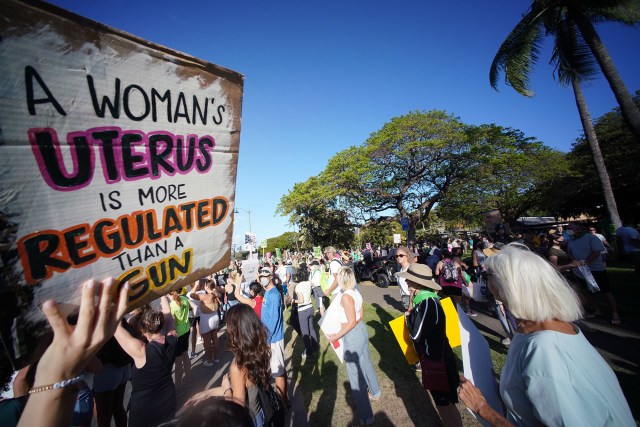 Demonstrators gather at the entrance near the Honolulu Zoo in a rally and march to defend the right to abortion.